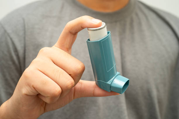 istock Asthma and chronic obstructive pulmonary disease COPD, Asian young man using metered dose inhaler MDI. 2205834836