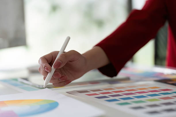 istock Digital Illustration and Color Selection. A graphic designer enhances artwork using a stylus. 2205835724