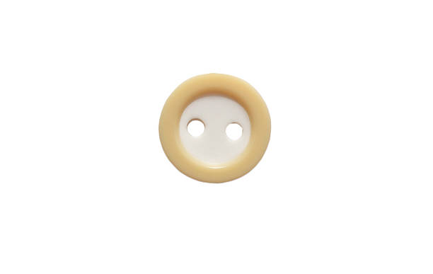 istock Yellow button with two holes close-up isolated on white background 2205836931