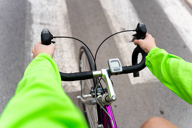 istock Cyclist riding bicycle on crosswalk, first-person perspective 2205842091