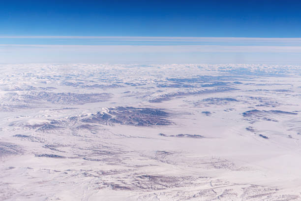 Tangla Mountain range in China, snow-capped mountain ranges like a moonscape under snow. Inner Mongolia View from an airplane window from a high altitude