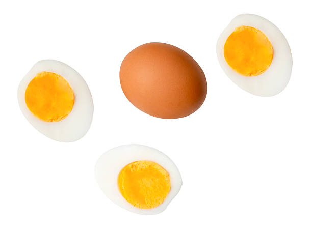 istock Top view set of raw brown chicken egg and cooked or boiled chicken eggs with egg yolk in three halves isolated on white background with clipping path 2205842279