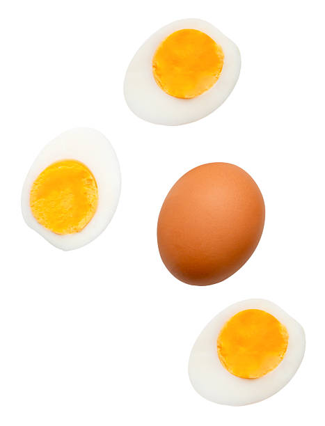 istock Top view set of raw brown chicken egg and cooked or boiled chicken eggs with egg yolk in three halves isolated on white background with clipping path 2205842282
