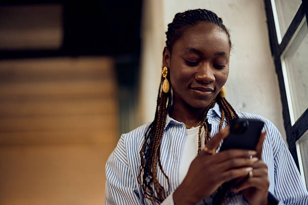 istock Woman Enjoying Smartphone Interaction in a Modern Bright Indoor Setting 2205842393