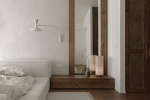 istock The bedroom features a solid oak bedside table, rattan closet, tall mirror. Soft linen bed linens drape the bed, while clay wall decor adds earthy elegance, creating a tranquil, imperfect sanctuary. 2205842421