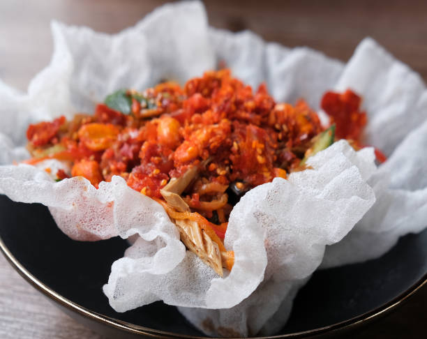 Spicy salad with seafood, fuzhou, squid, mix vegetables, peanut, sesame, mushroom, crispy puffed rice. Vacations and having lunch in the terrace of guest house hotel.