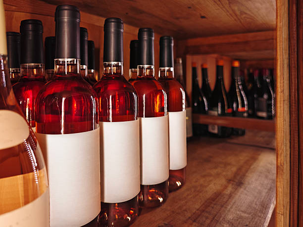 istock Sweet dessert red or rose wine bottles with empty labels close-up. 2205844270