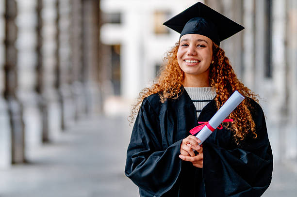 istock Young latin graduate smiling and holding her diploma 2205845713