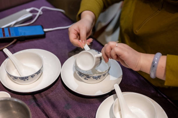 istock A woman is using hot water to iron dishes in a Cantonese style tea restaurant 2205845913