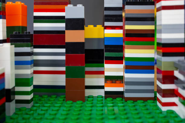 Tall building blocks towers background on green desk , abstract  backdrop