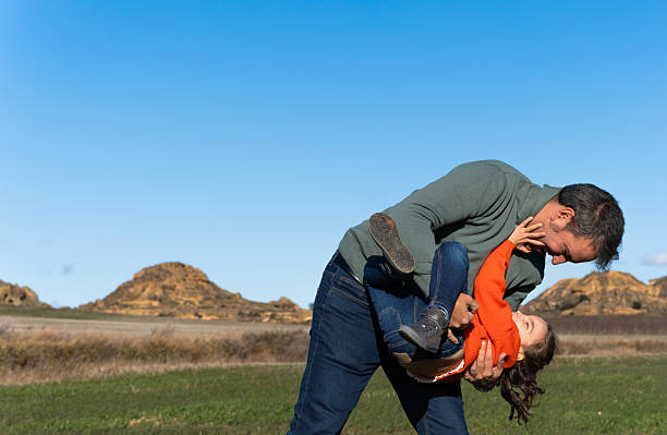 dad and his daughter are having fun on their farm