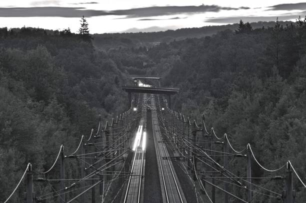 Motion of passing trains captured through light trails, enhancing a dynamic and futuristic feel