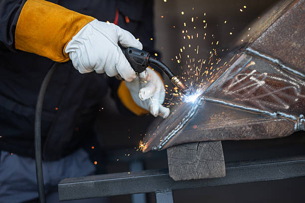 istock Welder joining metal parts with welding torch creating sparks 2205850136