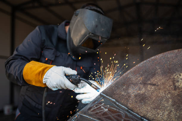 istock Metal worker welding steel structure with sparks flying 2205850238