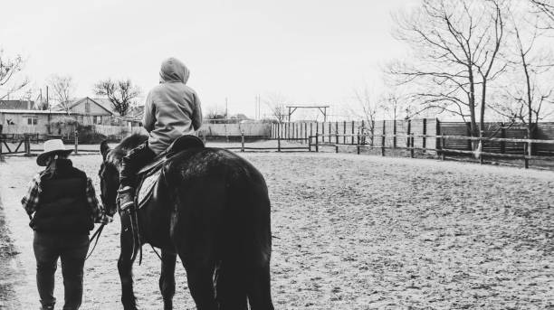 boy riding horse on ranch