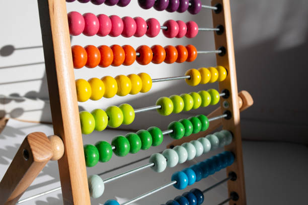 istock Bright colored hand abacus. Children's wooden toy for the study of arithmetic. 2205853324