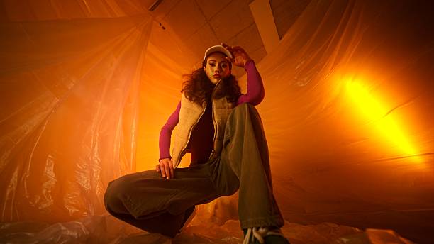 A stylish indoor portrait enhanced by dramatic lighting and captivating fashion