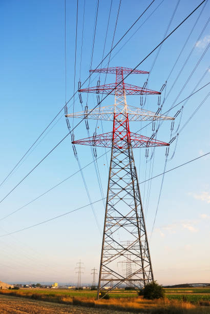 istock Electricity power transmission line pylons 2205859548