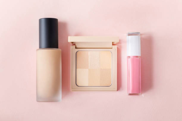 Decorative cosmetics set. Foundation, compact powder, lip gloss.