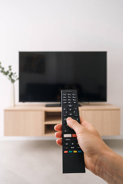istock Modern living room featuring a sleek LCD TV and a remote control 2205860550