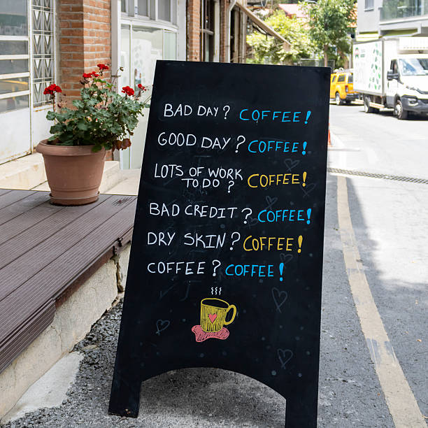 Humorous coffee shop chalkboard sign on the street in Pano Platres village, Cyprus