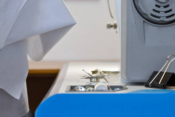 The studio cuts fabrics and sews clothes of different shapes and colors
