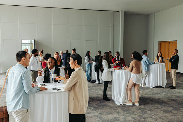 istock Diverse professionals networking and socializing at a business event 2205866891