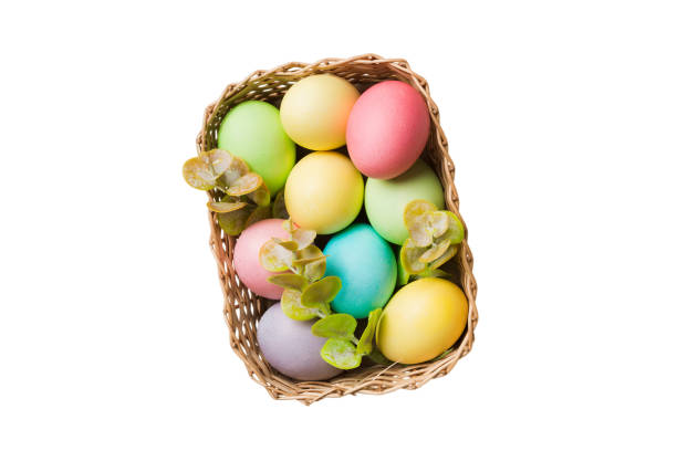 istock Basket of colorful Easter eggs isolated on white background. Easter basket filled with colored eggs top view holiday concept 2205867120