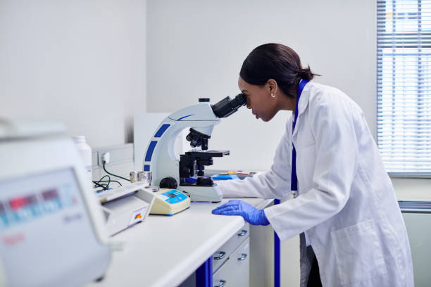 istock A shot of a female scientist or doctor looking into a microscope at micro organisms in a biochemistry laboratory 2205868692