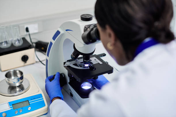istock A shot of a female scientist or doctor looking into a microscope at micro organisms in a biochemistry laboratory 2205868731