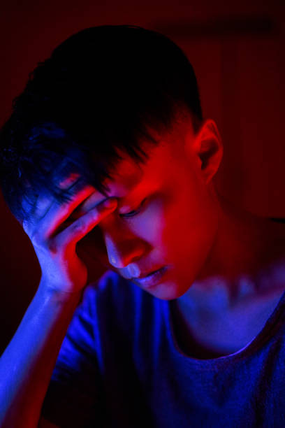 istock Red and blue lights illuminate the young man's face 2205871753