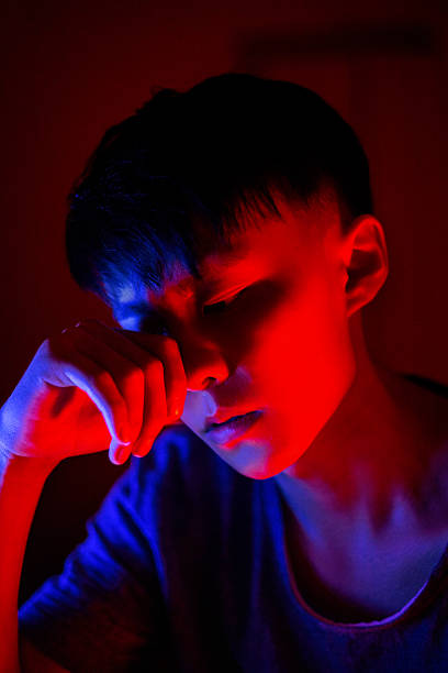 istock Red and blue lights illuminate the young man's face 2205871759
