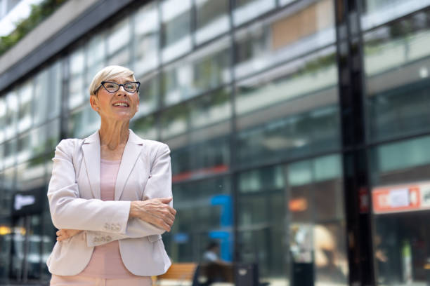 istock Senior lady crossing arms with contented expression 2205871925