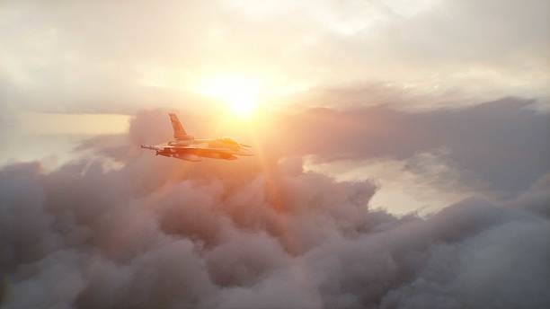 istock Military fighter jet F-16 flying over clouds. Air force. 3d rendering. 2205873302