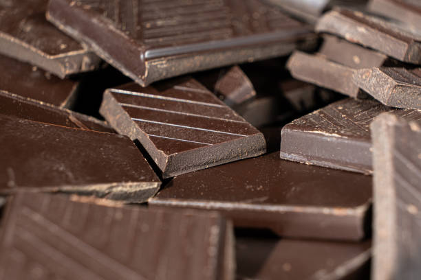 istock Delicious dark chocolate segments, rich black chocolate texture 2205878829