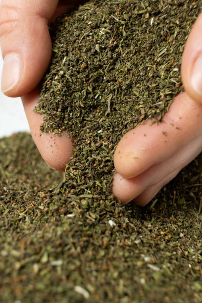 istock Hands pour dry crushed savory seasoning 2205878851