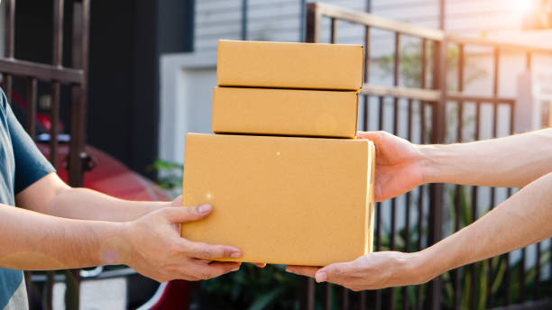 istock Man receiving parcel from delivery man, parcel delivery service for work from home people, parcel delivery with good depth of field 2205879175