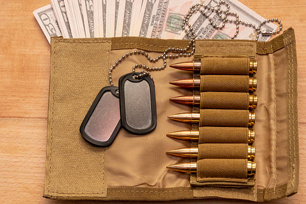 istock Live ammunition, army dog tags and cash 2205880425