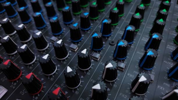 istock Close-up of an audio mixing console with multiple control knobs and buttons for sound adjustments. 2205883005
