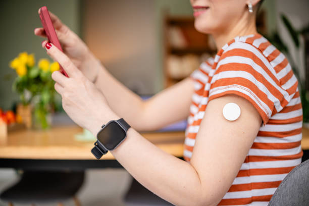 istock Young woman managing type 1 diabetes using technology at home while checking her glucose levels 2205883174
