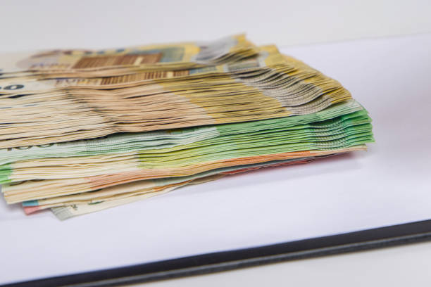 Euro banknotes stacked on a white background. Close-up.