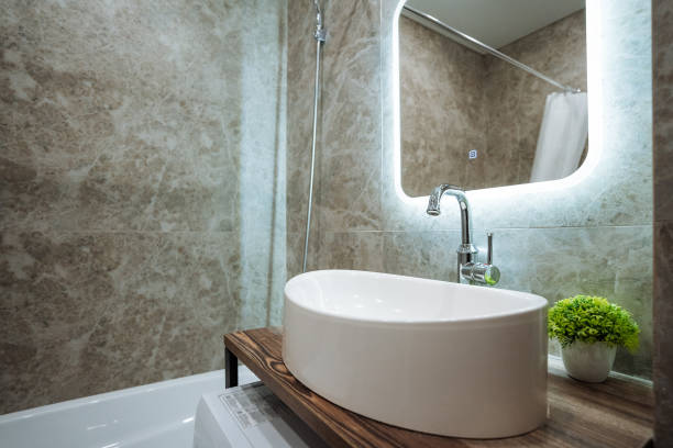The bathroom features essential fixtures a convenient sink, a mirror for selfchecks, and a comfortable bathtub perfect for relaxation after a long day, helping you unwind and rejuvenate