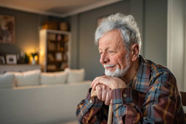 istock Senior man relaxing at home with walking stick: finding peace and serenity in old age 2205884380