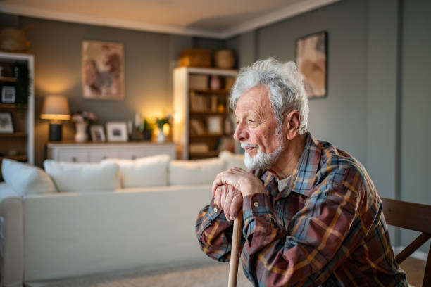 istock Senior man sitting at home, resting and looking away thoughtfully 2205884381