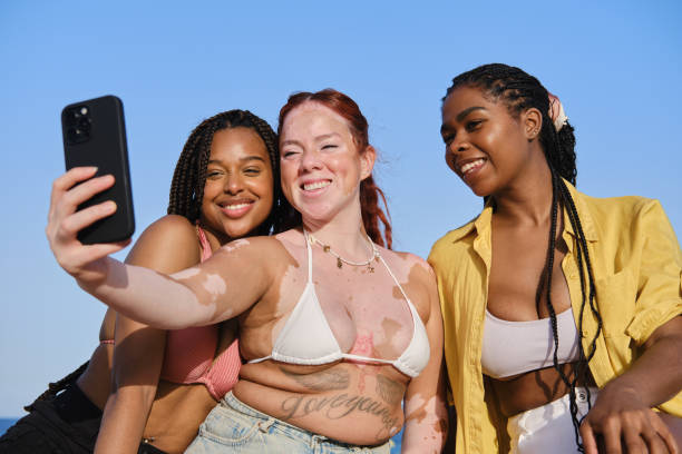 istock Three young women taking a selfie at the beach 2205884487
