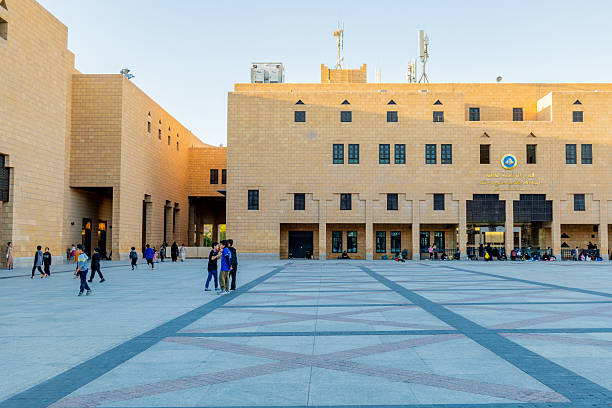 Riyadh locals enjoying a walk in Al Safat Square. The square  has a blend of traditional and modern Saudi architecture, often serving as a gathering point for events or festivals. It has historically been associated with public executions, earning it the nickname \