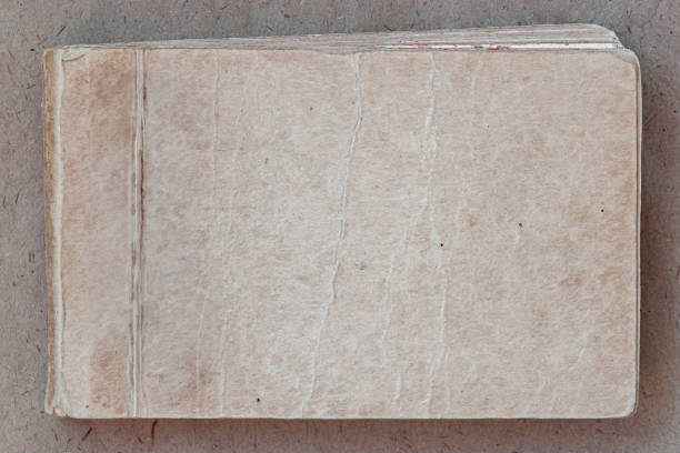 Old worn notebook, vintage texture, aged background, copy space. Aged vintage notebook with worn-out textured cover. Rustic and nostalgic background ideal for retro, antique, literary designs