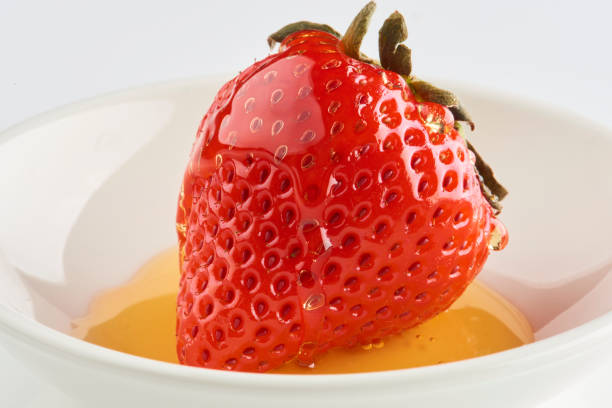 Strawberries with strawberry leaf and honey on a White background.