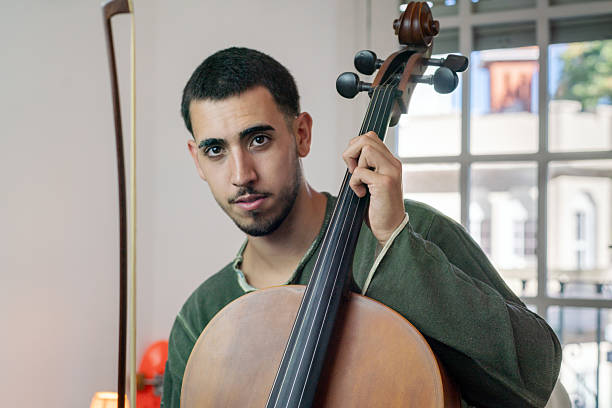 istock Portrait of Young musician playing cello with bow and strings. 2205886483
