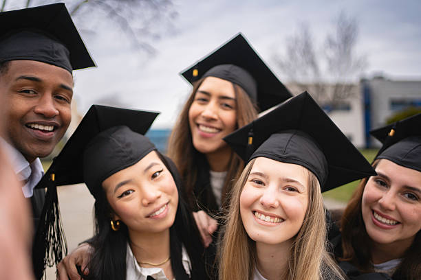 istock Happy multi-ethnic students taking a selfie celebrating their graduation day 2205888136